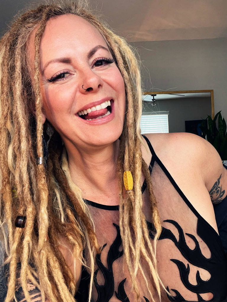 Marta Kagan laughing in a flame-print bodysuit